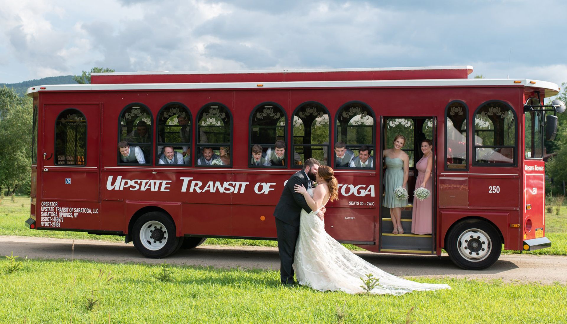 bride and groom kissing outside of trolley