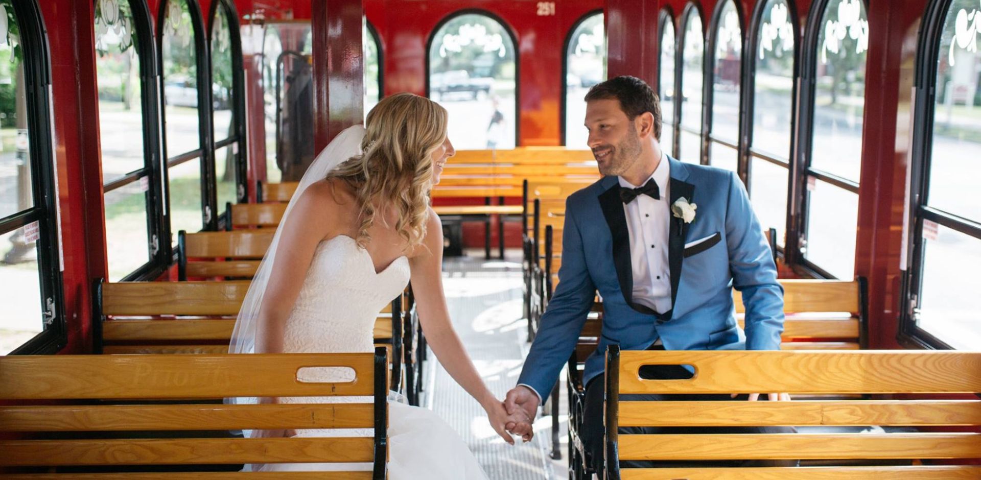 bride and groom holding hands on trolley