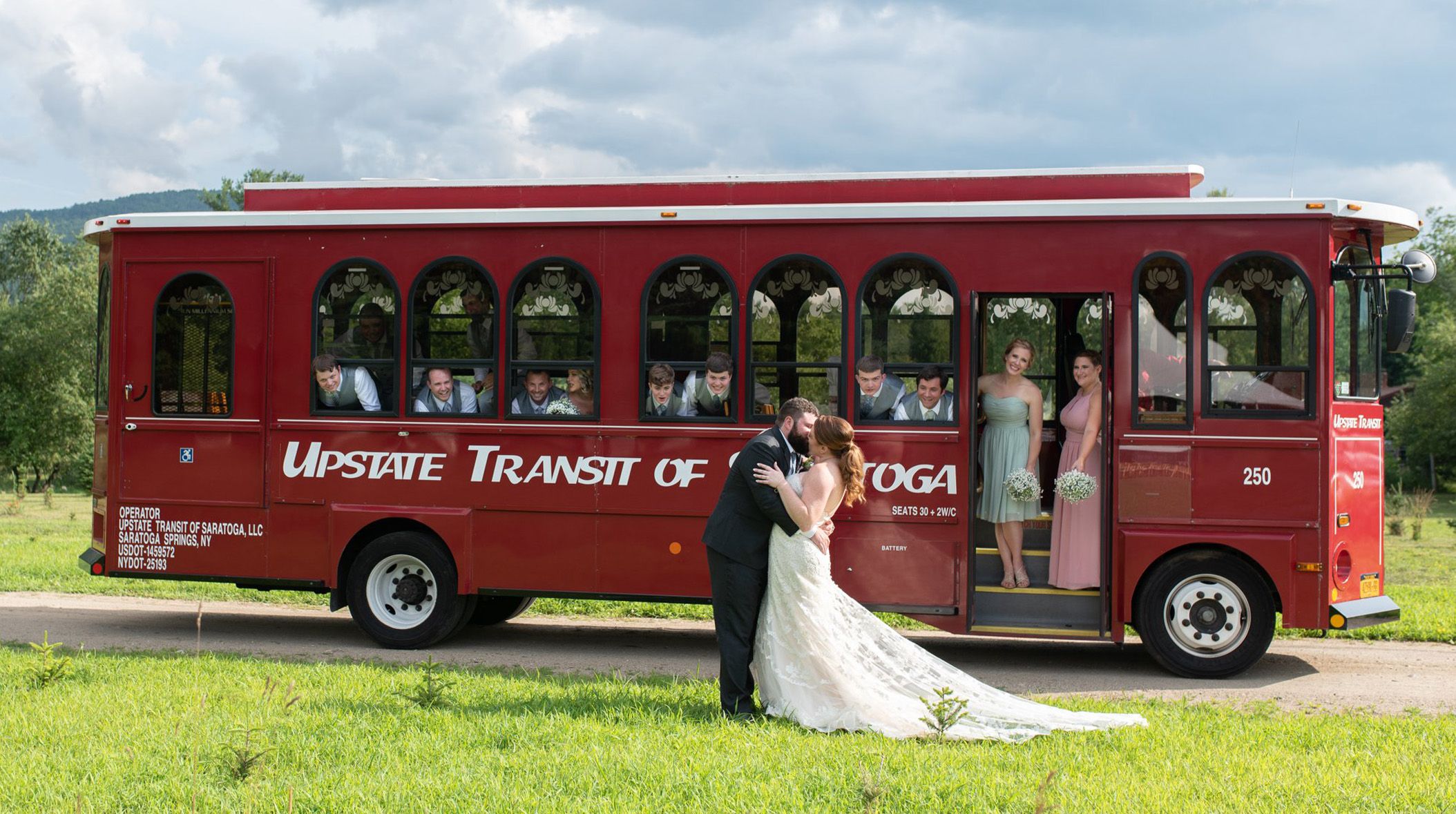 bride and groom kissing outside of trolley