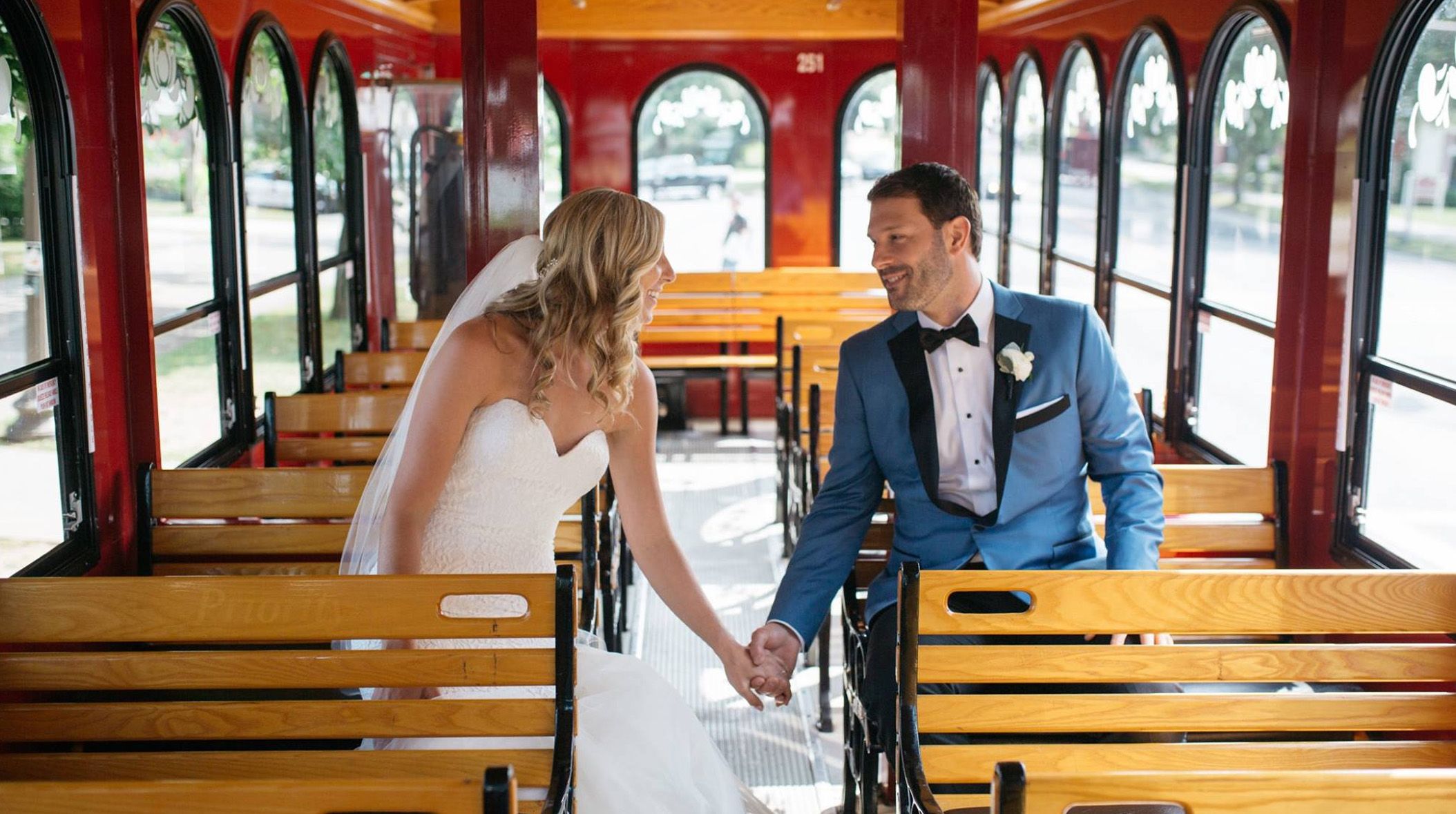 bride and groom holding hands on trolley